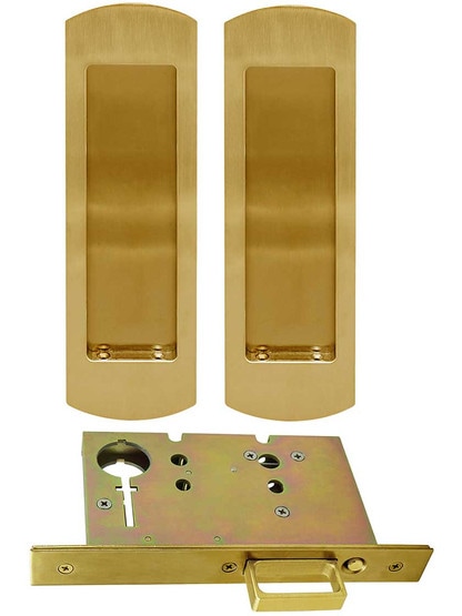 Premium Pocket-Door Mortise Lock Set with Rounded Pulls in Aged Brass.